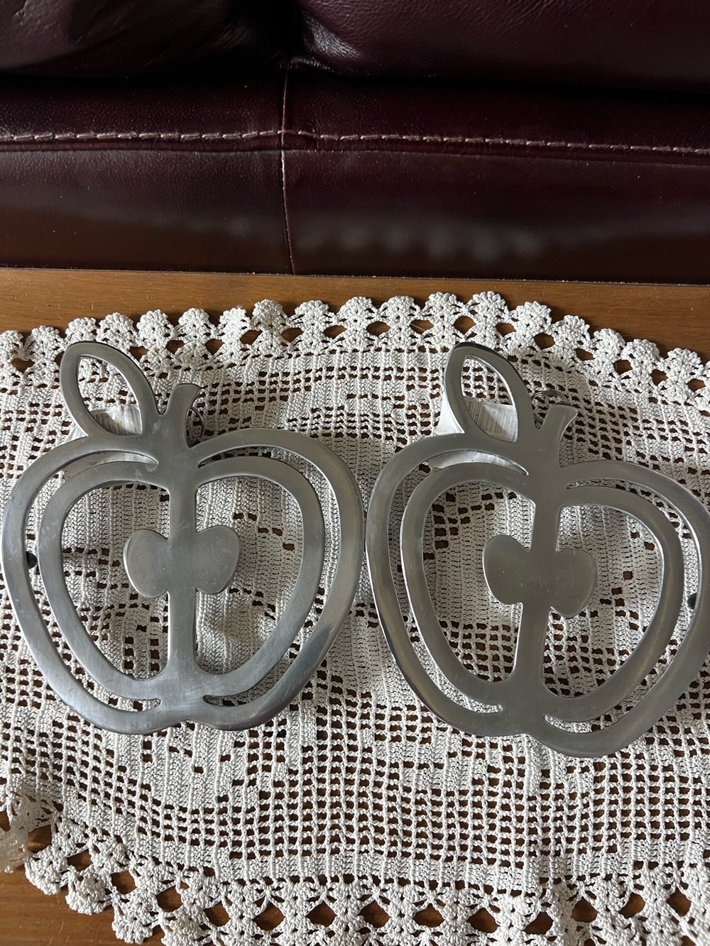 Copco polished cast aluminum Apple Trivets. Measures 7 1/2”x6 1/2” set of two.